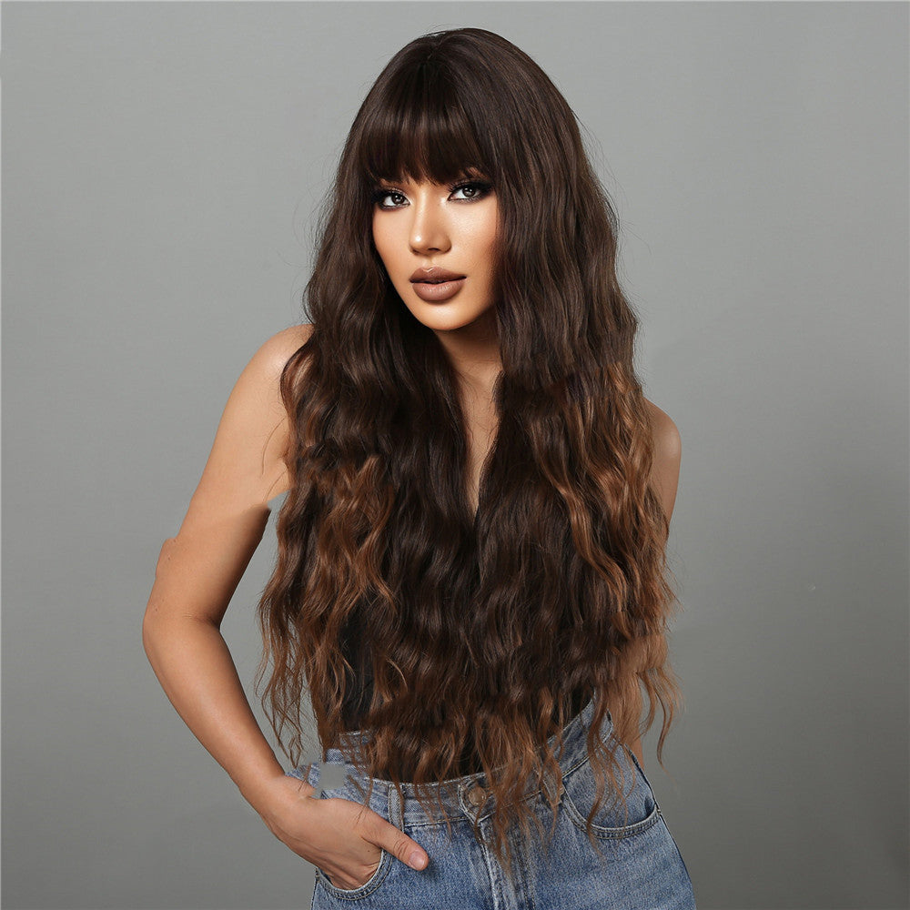 Woman with long, wavy brown hair against a gray background